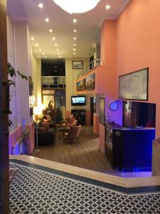 a lobby with a living room and a tv at Hotel Crowded House in Eceabat
