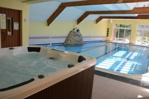 a large swimming pool with a large tub in the middle at Apartments Gite le Picors in Aucun