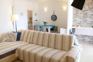 a living room with a couch and a table at SARDINIA RE - Attico Baja Ostina in Castelsardo