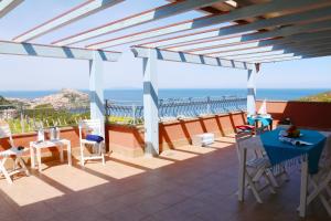 a patio with a view of the ocean at SARDINIA RE - Attico Baja Ostina in Castelsardo