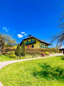 a yellow house on the side of a road at Haus Dietrich am Red Bull Ring in Spielberg