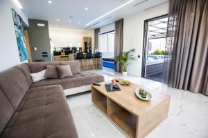 a living room with a brown couch and a table at Zambelis Athens Penthouse Spa in Athens
