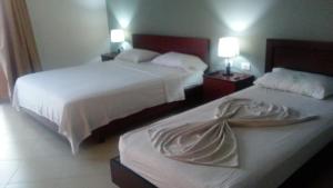 Postel nebo postele na pokoji v ubytování Hotel Majestic