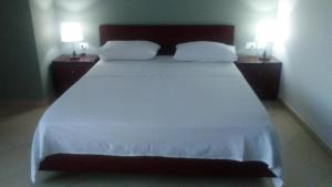 Postel nebo postele na pokoji v ubytování Hotel Majestic