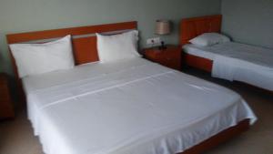 Postel nebo postele na pokoji v ubytování Hotel Majestic