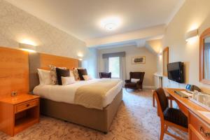 a hotel room with a bed and a television at Appleby Manor Hotel & Garden Spa in Appleby