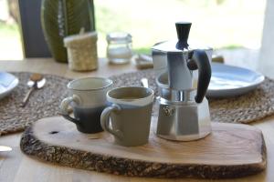 a coffee maker and two cups on a wooden tray at Bed & Breakfast IL PAJO in Padenghe sul Garda