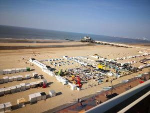 an aerial view of a beach with umbrellas and a pier at Luxe seaview appartment in Blankenberge