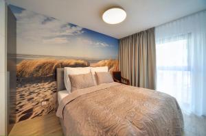 Postel nebo postele na pokoji v ubytování Przytulne i Nowoczesne Apartamenty Sun Seasons 24 w Dziwnowie z Parkingiem by Noclegi Renters