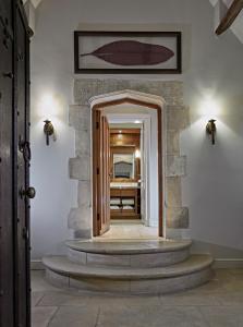 a hallway with a stairway leading to a room at Whatley Manor in Malmesbury