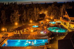 an overhead view of two pools at night at Atostogų Parkas Hotel in Palanga