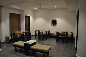 
a room with a table, chairs, and tables at Thyme the Transit in Bangalore

