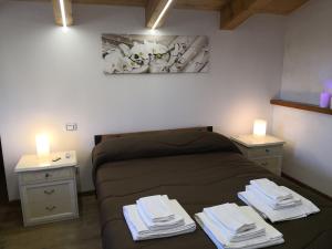 a bedroom with a bed with two night stands and two lights at Il Quadrifoglio in Massa Lubrense