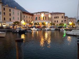 a marina at night with boats in the water at La Casa di Anna in Gargnano