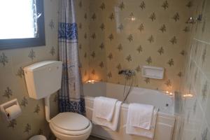 a bathroom with a tub and a toilet and a sink at Triantafyllia's House in Agios Ioannis Pelio +50 photos