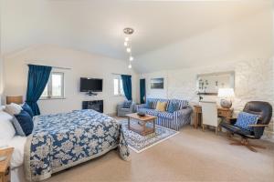 a bedroom with a bed and a living room at Canaston Oaks in Narberth