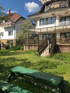 a green picnic table in front of a house at Luxury Eagle apartman in Budapest