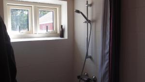 a shower stall in a bathroom with a window at Bjældskovgaard Holiday House in Funder Kirkeby +18 photos