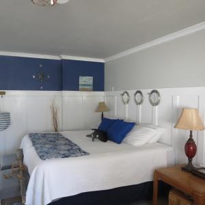 
a bedroom with a bed and a lamp at Tanbark Shores Guest Suite in Brookings
