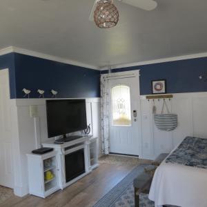 a living room with a flat screen tv on a wall at Tanbark Shores Guest Suite in Brookings
