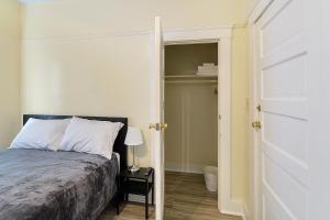 a bedroom with a bed next to a closet at Pads on Pasadena Ave in Los Angeles