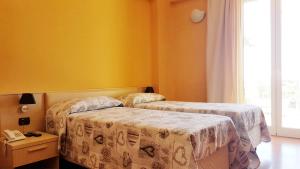 Postel nebo postele na pokoji v ubytování Hotel Paclà
