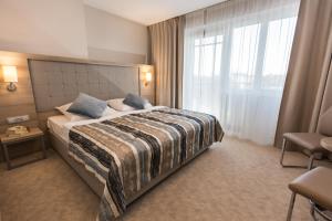 Łóżko lub łóżka w pokoju w obiekcie Villa Bravo & SPA
