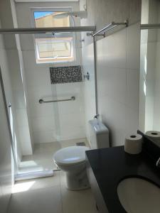 a bathroom with a toilet and a glass shower at Flat de luxo em Lagoa Santa/MG in Lagoa Santa +16 photos