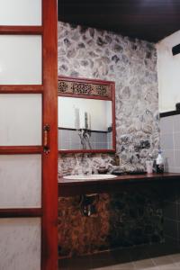 a bathroom with a mirror and a sink at Villa Darakorn Hill Country House in Chiang Rai