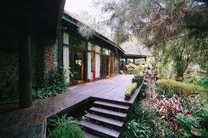 a porch with a bench in front of a building at Villa Darakorn Hill Country House in Chiang Rai