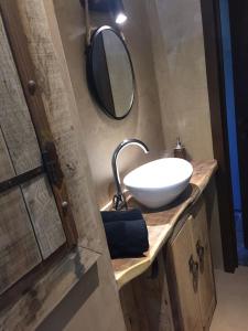 a bathroom with a white sink and a mirror at Côté Campagne in Durbuy