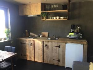 a kitchen with a wooden counter and a sink at Côté Campagne in Durbuy +8 photos