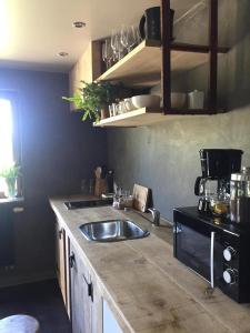 a kitchen with a sink and a counter top at Côté Campagne in Durbuy