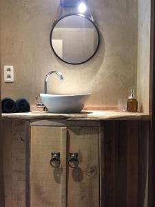 a bathroom with a sink and a mirror on a counter at Côté Campagne in Durbuy