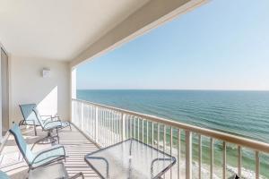 a balcony with chairs and a view of the ocean at Majestic Beach Resort in Panama City Beach