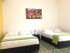 Postel nebo postele na pokoji v ubytování Hotel Balcones de Bocagrande