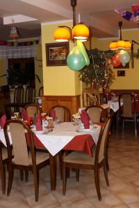 a dining room with a table with red napkins at Penzion Nikola in Pec pod Sněžkou