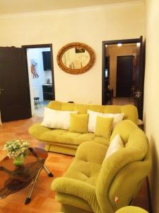 a living room with a couch and a mirror at Guest House, Old-Si in Tbilisi City