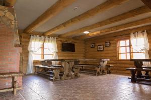 a room with a wooden table in a room with windows at Tindioru Holiday House in Rõuge