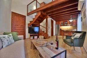 a living room with a couch and a table at Unique luxury suites in Hydra