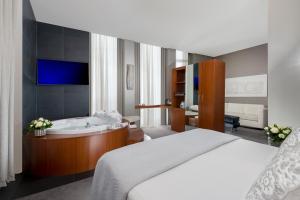 a hotel room with a large bed and a large mirror at Metropolis - Hotel di Charme in Rome