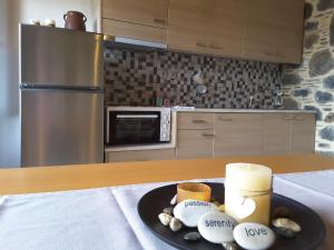 a kitchen with a plate of food on a table at Panorama Apartment in Kefálion