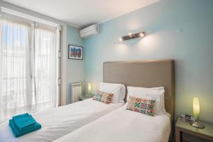 a bedroom with two beds and a window at LV Premier Apartments Baixa- PR in Lisbon