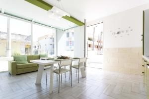 a dining room with a white table and chairs at Viva Vacanze in Porto Cesareo
