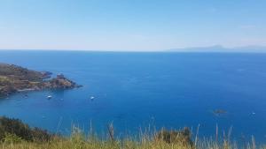 a large blue body of water with boats in it at Hotel Villa Principe in San Nicola Arcella