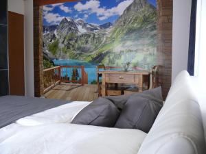 a bedroom with a mountain mural on the wall at Ferien Wohnung "Kaiser" mit Balkon und Garten in Offenhausen