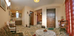 a living room with a table and a kitchen at Evaland Traditional Houses in Tarti