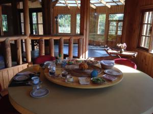 a table with food on it in a room with windows at B&B Casa Redonda in Santo Domingo