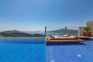 a swimming pool with a bed next to a swimming pool at Villa La Mer Azur in Kalkan