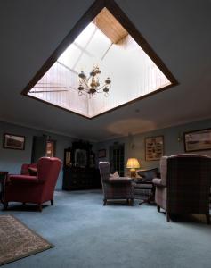 a large living room with a large skylight at Altnaharra Hotel in Lairg